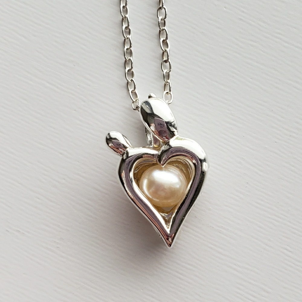 Vantel Pearl's mother and child cage necklace.
